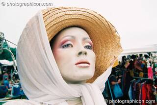 Female mannequin wearing hat and headscarf as if on a strole at Big Green Gathering 2003. Cheddar, Great Britain. © 2003 Photographicon