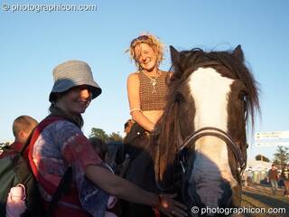A woman on horseback talks to a friend at Big Green Gathering 2007. Burrington, Cheddar, Great Britain. © 2007 Photographicon