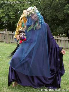 Woman in blue dress carrying a figurine of Magdalene at the Feast of the Magdalene. Glastonbury, Great Britain. © 2005 Photographicon