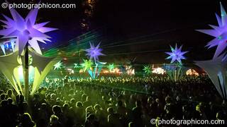 A night view from above the crowd of dancers amongst the illuminated inflatable Tribe of Frogs decor by the Origin Stage at Glade Festival 2006. Aldermaston, Great Britain. © 2006 Photographicon