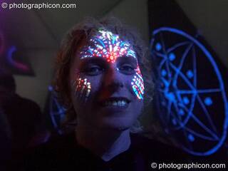 A woman with UV fluro face paint at Planet Bob's Offworld Festival 2007. Swindon, Great Britain. © 2007 Photographicon