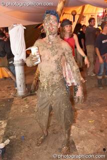 A man person covered in mud and straw at the Secret Garden Party 2006. Huntingdon, Great Britain. © 2006 Photographicon