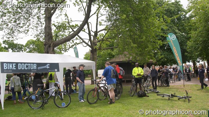 People queuing for the popular Bike Doctor free bicycle inspection service at the London Green Lifestyle Show 2005. Great Britain. © 2005 Photographicon