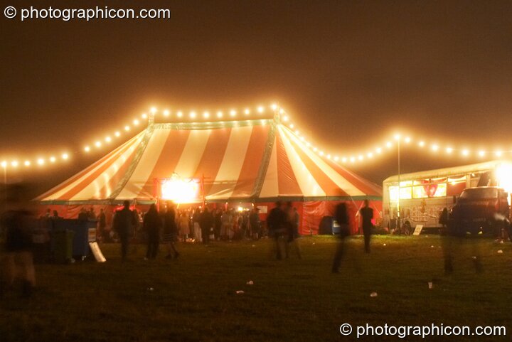 Long strings of fairy lights strung across the marquees glow in the night mist at the Lost Vagueness Summer Party 2004. Lewes, Great Britain. © 2004 Photographicon