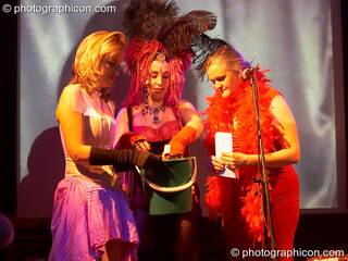 Ellie, Kwali, & Bernadette draw raffle tickets at the Save The World Club Burlesque Ball. Kingston upon Thames, Great Britain. © 2005 Photographicon