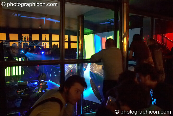 Looking out of the glass bar reveals a visual show in the main Future Funk Room at Future Music. London, Great Britain. © 2008 Photographicon