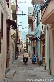 Man on scooter vanishes down a side street in Rethymno. Greece. © 2002 Photographicon
