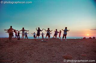 A group of people practising Tai Chi as the sun sets on a cliff at Agios Pavlos. Greece. © 2002 Photographicon