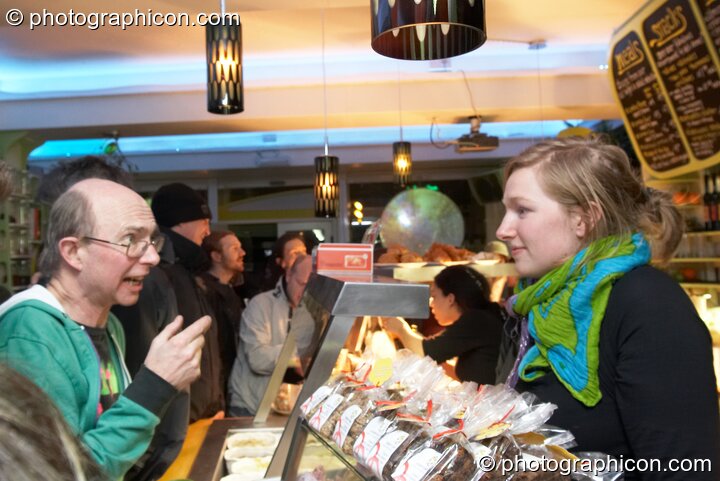 Staff serve behind the cafe counter at the launch party for the inSpiral Lounge organic cafe and multimedia venue. London, Great Britain. © 2007 Photographicon