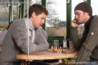 Two men play chess at a table in the inSpiral Lounge organic cafe and multimedia venue. London, Great Britain. © 2008 Photographicon