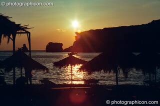 The golden sun sets over the beach and peninsula at Agios Pavlos. Greece. © 2002 Photographicon
