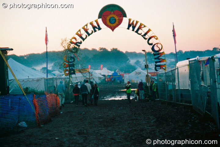 Leaving via the welcome gate as the early morning mist rises at Big Green Gathering 2003. Cheddar, Great Britain. © 2003 Photographicon