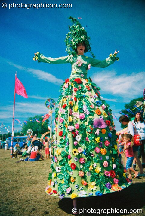 Stilted woman in big carnival dress at Big Green Gathering 2003. Cheddar, Great Britain. © 2003 Photographicon