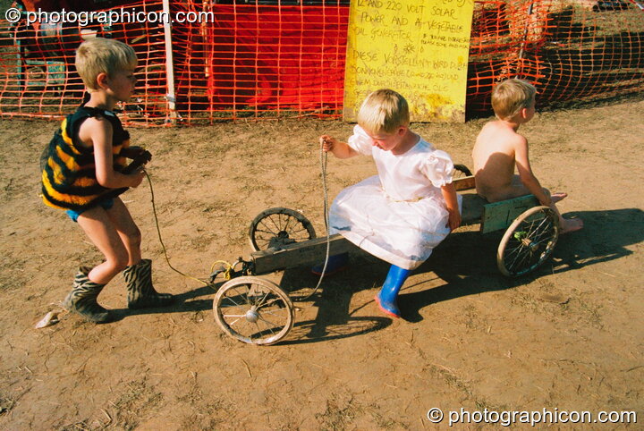 Kids playing on a go-cart at Big Green Gathering 2003. Cheddar, Great Britain. © 2003 Photographicon