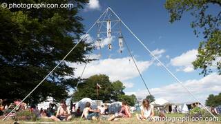 People chilling under a large pyramidal frame at Big Green Gathering 2005. Burrington, Cheddar, Great Britain. © 2005 Photographicon