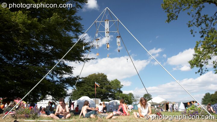 People chilling under a large pyramidal frame at Big Green Gathering 2005. Burrington, Cheddar, Great Britain. © 2005 Photographicon