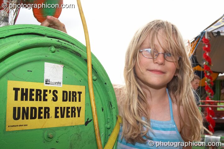 A young girl points out a sign on the Rinky-Dink mobile pedal-powered sound-system at Big Green Gathering 2006. Burrington, Cheddar, Great Britain. © 2006 Photographicon