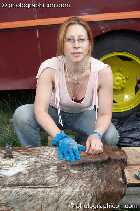 A woman prepares a goat skin for use on a drum in the Green Crafts field at Big Green Gathering 2006. Burrington, Cheddar, Great Britain. © 2006 Photographicon