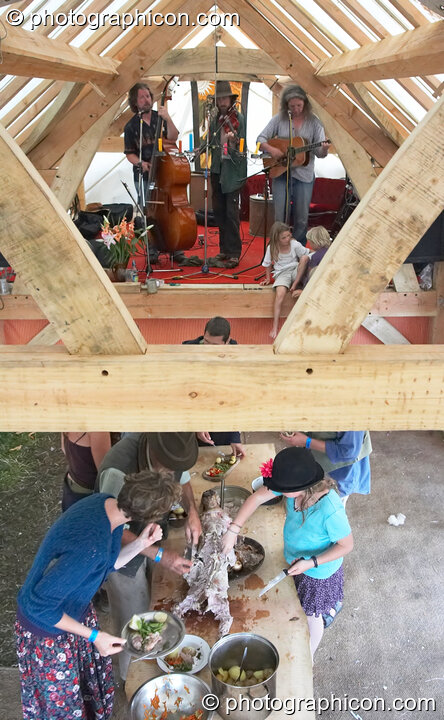 The Weird String Band playing on the Barn Gallery stage while guests eat the banquet food at Big Green Gathering 2006. Burrington, Cheddar, Great Britain. © 2006 Photographicon