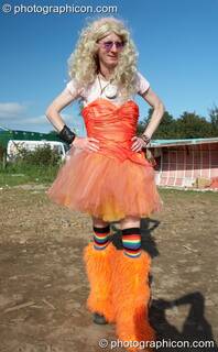 A man wearing a wig, red dress, and orange leggings at Big Green Gathering 2007. Burrington, Cheddar, Great Britain. © 2007 Photographicon