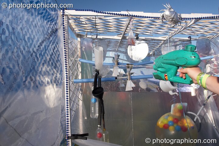 A fairground water-pistol game at Big Green Gathering 2007. Burrington, Cheddar, Great Britain. © 2007 Photographicon