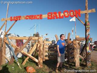 A man leaves through the swinging wooden gates outside the Last Chance Saloon at Big Green Gathering 2007. Burrington, Cheddar, Great Britain. © 2007 Photographicon