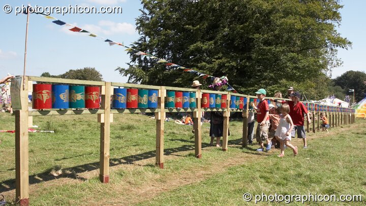 A group of youths turn the Tibetan Buddhist prayer wheels in the Healing Field at Big Green Gathering 2007. Burrington, Cheddar, Great Britain. © 2007 Photographicon