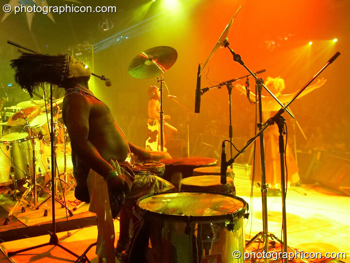 A masked African drummer performs with Juno Reactor on the Glade Stage at Glade Festival 2006. Aldermaston, Great Britain. © 2006 Photographicon