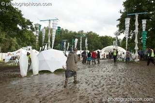 People walking in the mud around the IDspiral arena at Glade Festival 2007. Aldermaston, Great Britain. © 2007 Photographicon