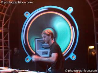Richie Hawtin performs with his head profiled by a giant painted speaker backdrop on the Vapor Stage at Glade Festival 2007. Aldermaston, Great Britain. © 2007 Photographicon