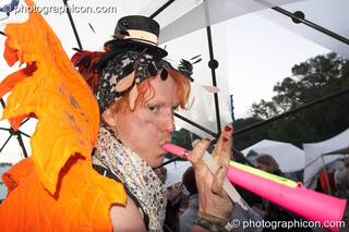 A man wearing a wonky winged costume blows his horn in the IDspiral dome at Glade Festival 2007. Aldermaston, Great Britain. © 2007 Photographicon