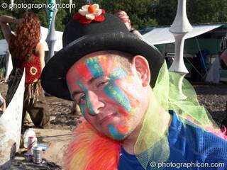 A man wearing a painted face and hat gives a sideways look at Glade Festival 2007. Aldermaston, Great Britain. © 2007 Photographicon