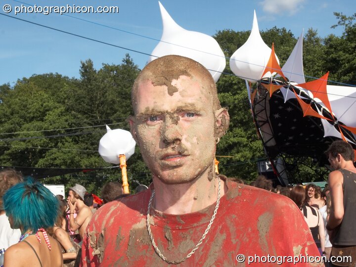 A man covered in mud dances outside the Origin Stage at Glade Festival 2007. Aldermaston, Great Britain. © 2007 Photographicon