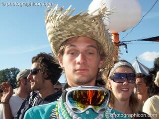A drunk man wearing a straw hat and ski glasses dances outside the Origin Stage at Glade Festival 2007. Aldermaston, Great Britain. © 2007 Photographicon