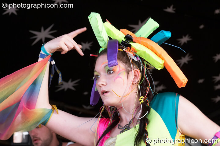 A woman wearing a fluro outfit dances on the Origin Stage at Glade Festival 2007. Aldermaston, Great Britain. © 2007 Photographicon
