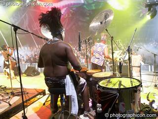A masked African drummer framed against the illuminated crowd performs with Juno Reactor on the Glade Stage at Glade Festival 2006. Aldermaston, Great Britain. © 2006 Photographicon
