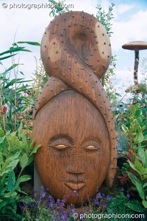 A wooden carving of a woman's head at Glastonbury Festival 2002. Pilton, Great Britain. © 2002 Photographicon