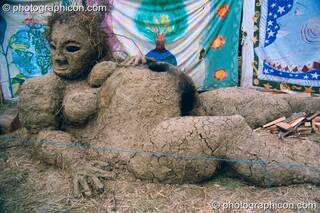 A clay and straw sculpture of a pregnant woman that is also a bread oven at Glastonbury Festival 2002. Pilton, Great Britain. © 2002 Photographicon