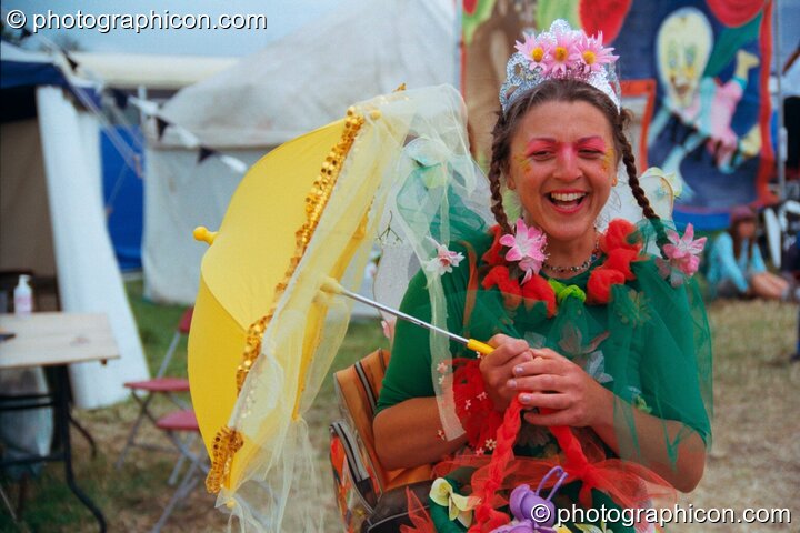 Colourful woman with umbrella at Glastonbury Festival 2002. Pilton, Great Britain. © 2002 Photographicon
