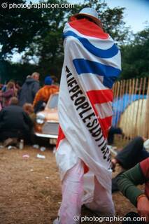 Woman wrapped in large banner for the Peoples Lotto in the Lost Vaguess field at Glastonbury Festival 2002. Pilton, Great Britain. © 2002 Photographicon