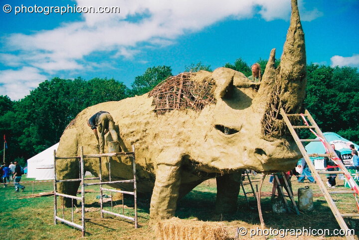 Large wicker and mud sculpture of a rhino in the Green Futures field at Glastonbury Festival 2003. Pilton, Great Britain. © 2003 Photographicon