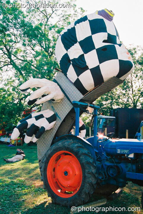 A sculpture of a head attached to a tractor in the Lost Vagueness field at Glastonbury Festival 2003. Pilton, Great Britain. © 2003 Photographicon