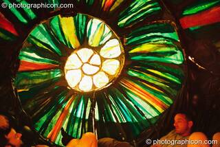 Inside a large snail shell seating chamber at Glastonbury Festival 2003. Pilton, Great Britain. © 2003 Photographicon
