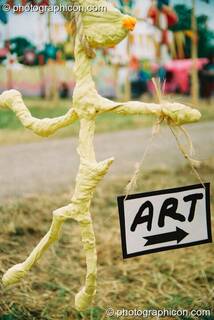 A stick figure holding an Art sign at Glastonbury Festival 2003. Pilton, Great Britain. © 2003 Photographicon