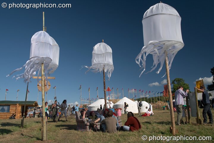 People relaxing by hanging decorations in the Green Future field at Glastonbury Festival 2004. Pilton, Great Britain. © 2004 Photographicon