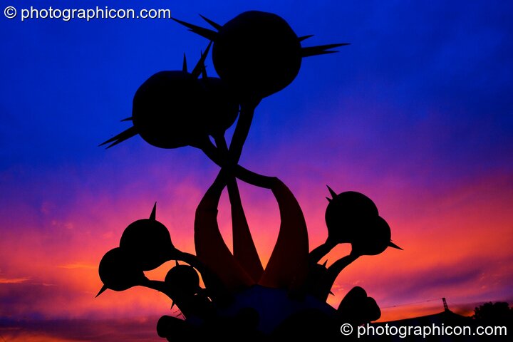 An inflateable sculpture against a colour-manipulated dawn sky at Glastonbury Festival 2004. Pilton, Great Britain. © 2004 Photographicon