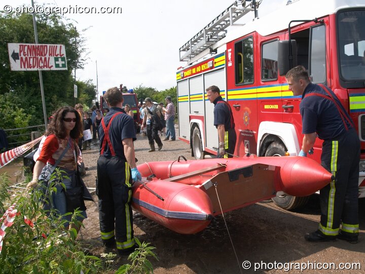 Somerset Fire Brigade arrive with a rescue raft after the Pennard Hill camp site flooded at Glastonbury Festival 2005. Pilton, Great Britain. © 2005 Photographicon