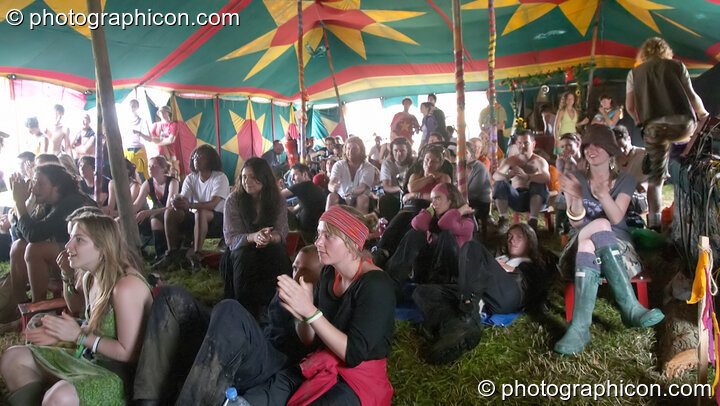 The audience cheers Martha Tilston on the Small World Stage (Green Futures field) at Glastonbury Festival 2005. Pilton, Great Britain. © 2005 Photographicon