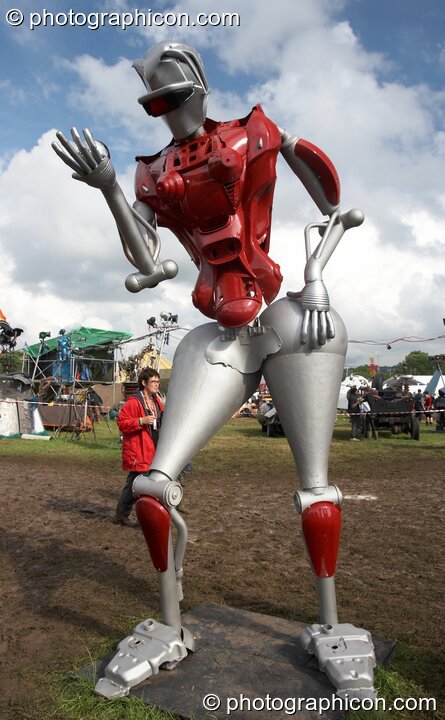 Mutoid Waste Company sculpture of a tall robot holding a reflective perfume ball in Trash City at Glastonbury Festival 2007. Pilton, United Kingdom. © 2007 Photographicon