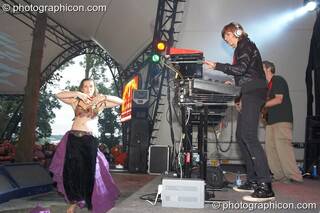 Amanda Heron performs a Raqs Sharqi dance while Miquette Giraudy and Steve Hillage of Mirror System (A-Wave) perform on the Glade Stage at Glastonbury Festival 2008. Pilton, Great Britain. © 2008 Photographicon